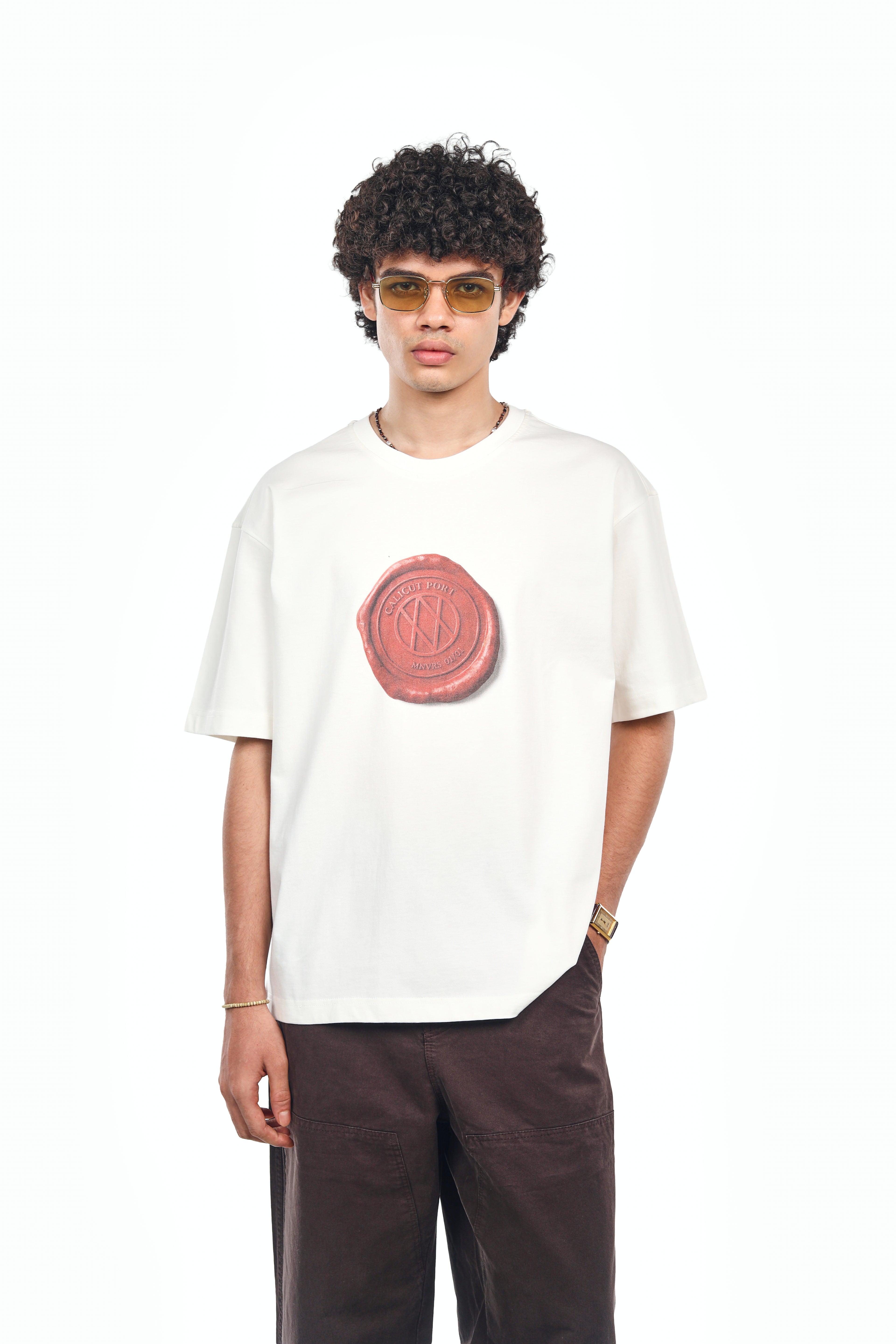 Man wearing the off-white MANIVERSE Wax Seal oversized t-shirt